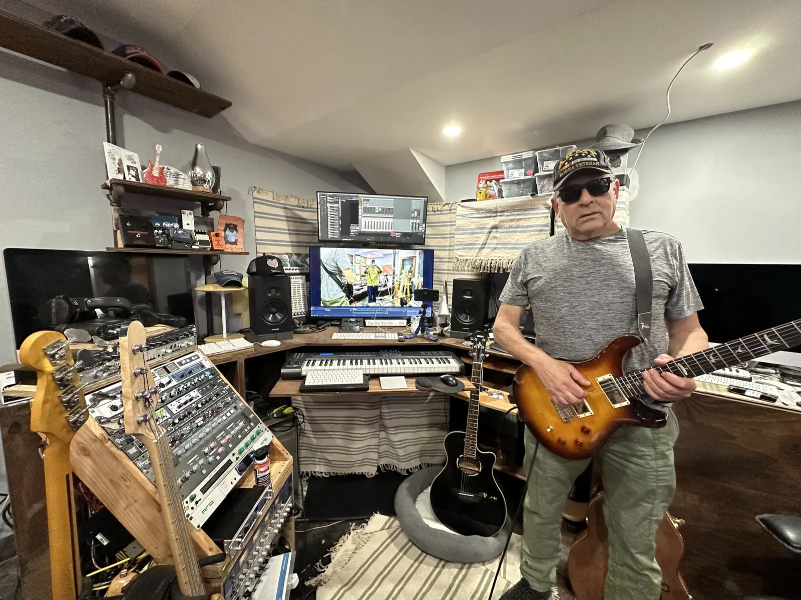Alan Kessler playing electric guitar in a home music studio